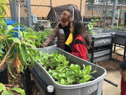 woman and child in a container garden