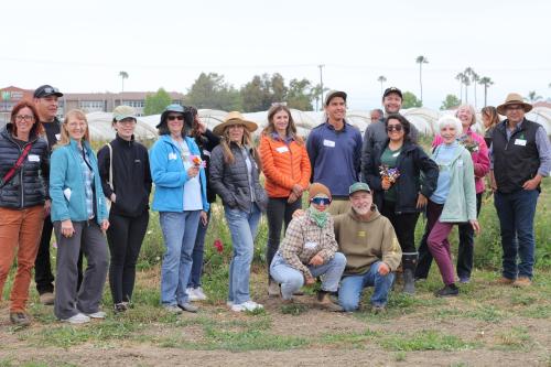 A group of 15 people in a field.